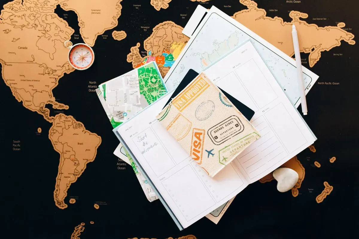 Travel documents and a passport laid out on a map